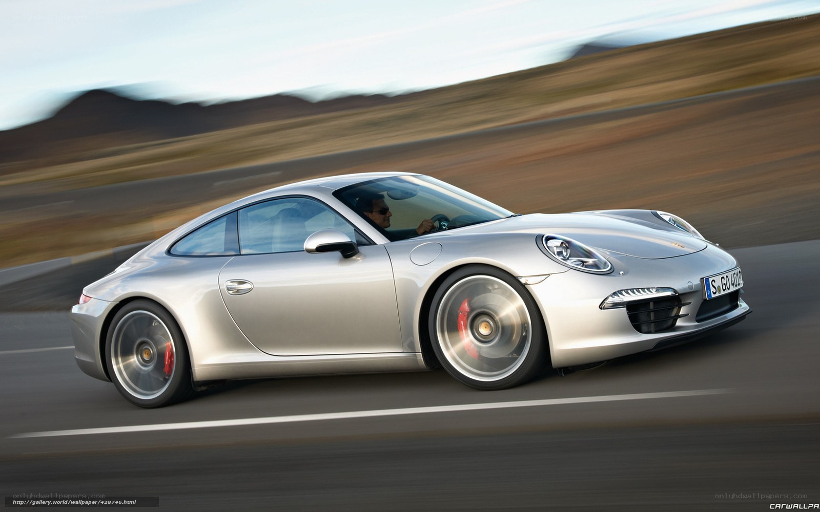silver porsche 911 in motion