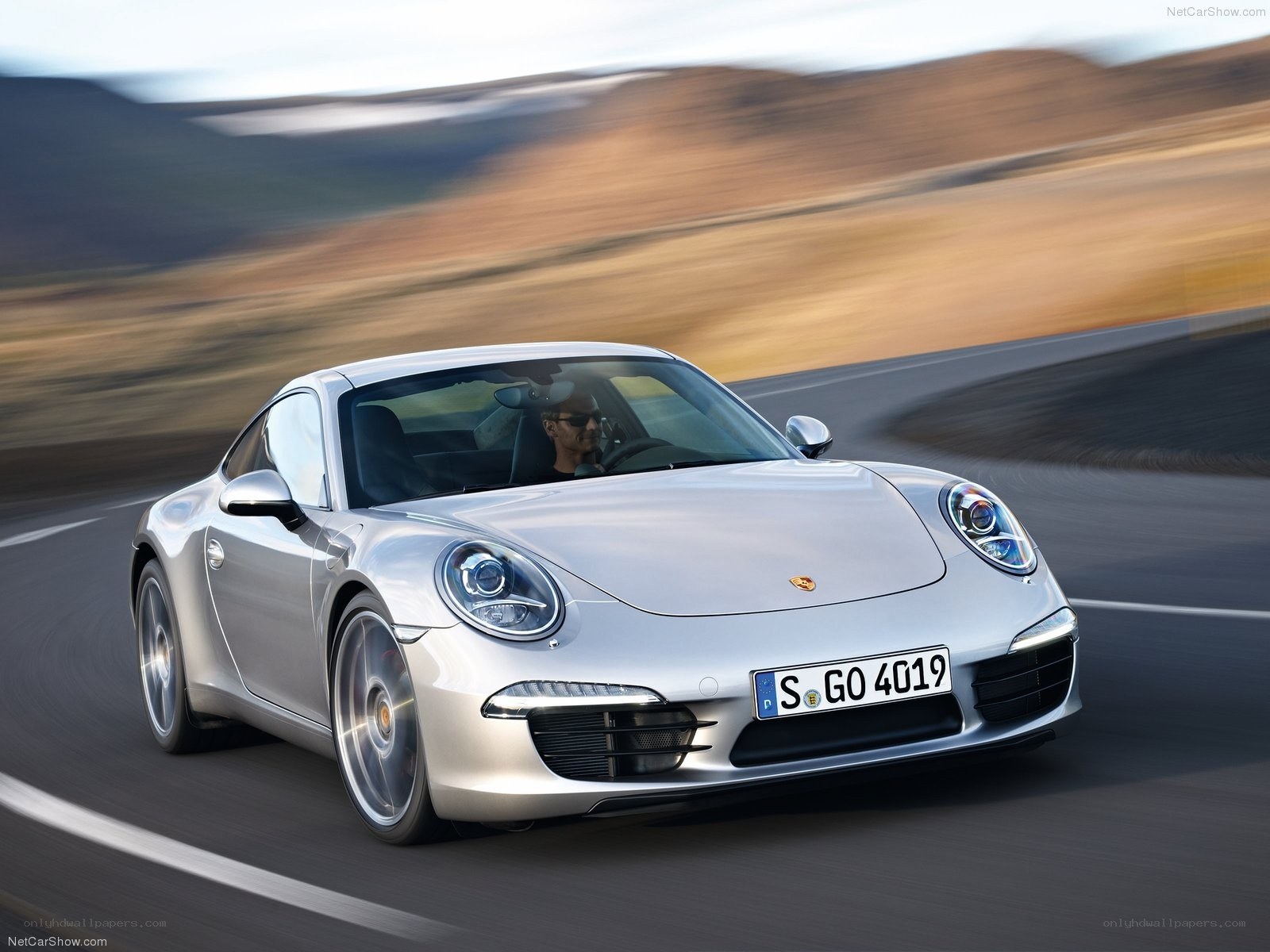 silver porsche 911 in motion