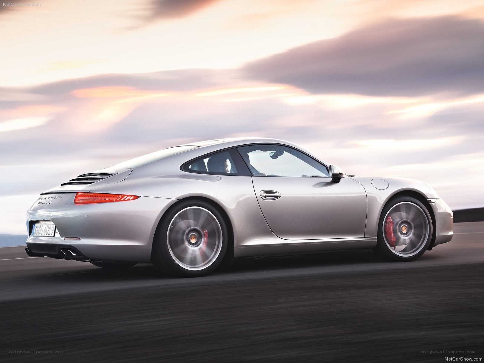silver porsche 911 in motion