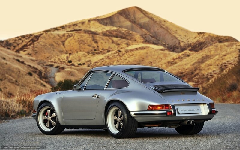 Silver Porsche 911 on a desert road