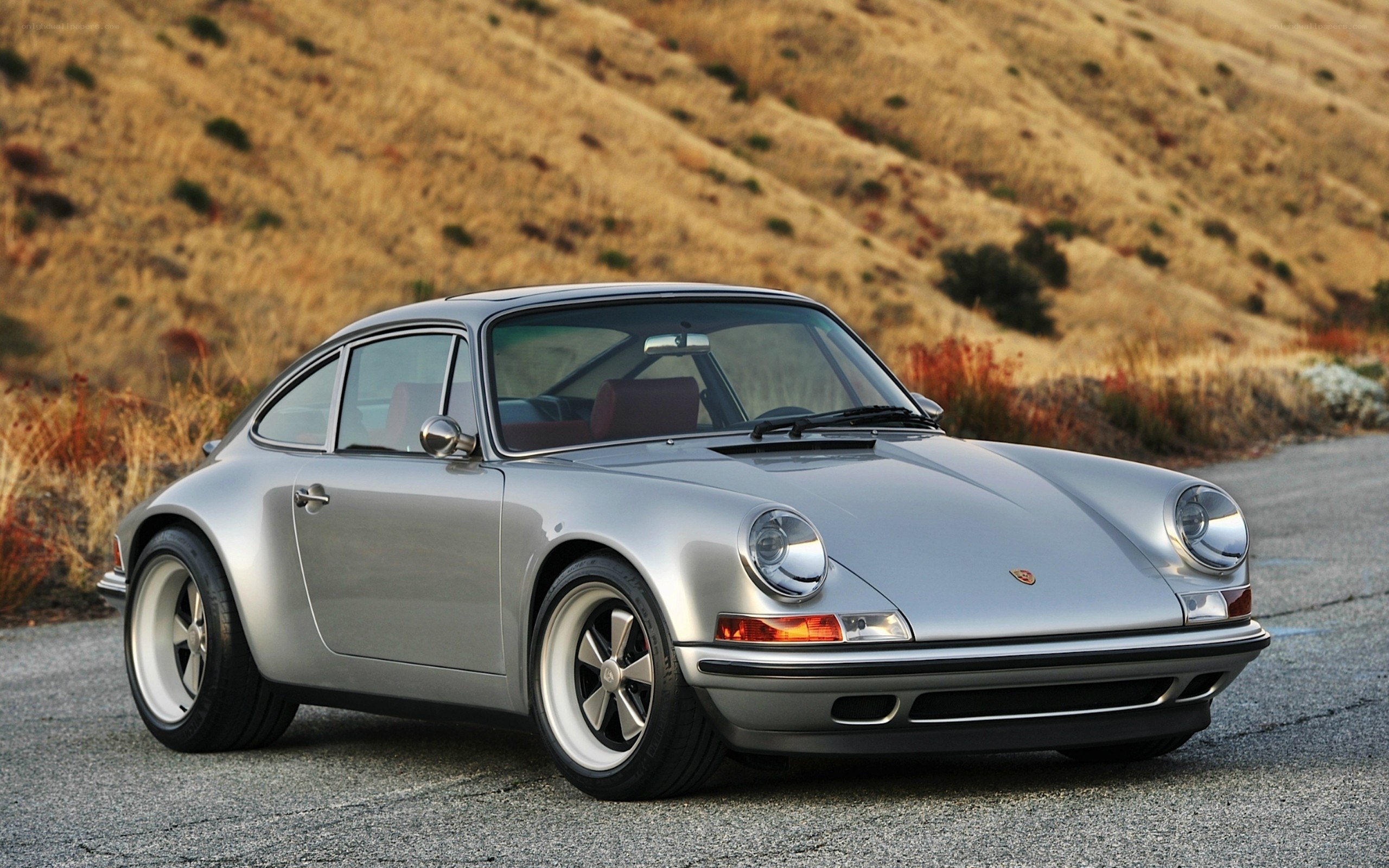 Silver Porsche 911 on a road