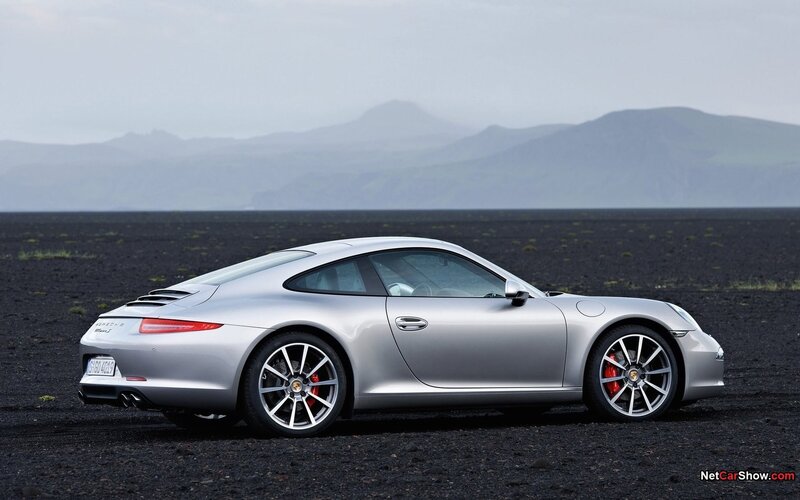 silver porsche 911 on black sand