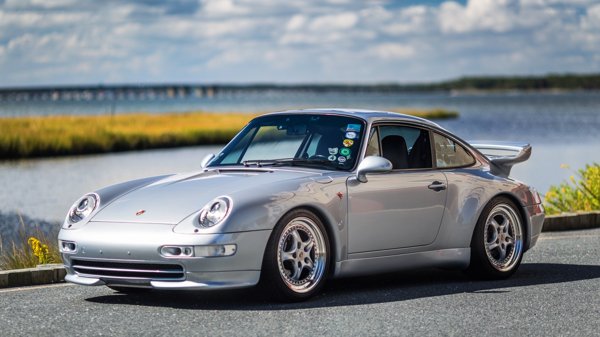 Silver Porsche 911 on waterfront