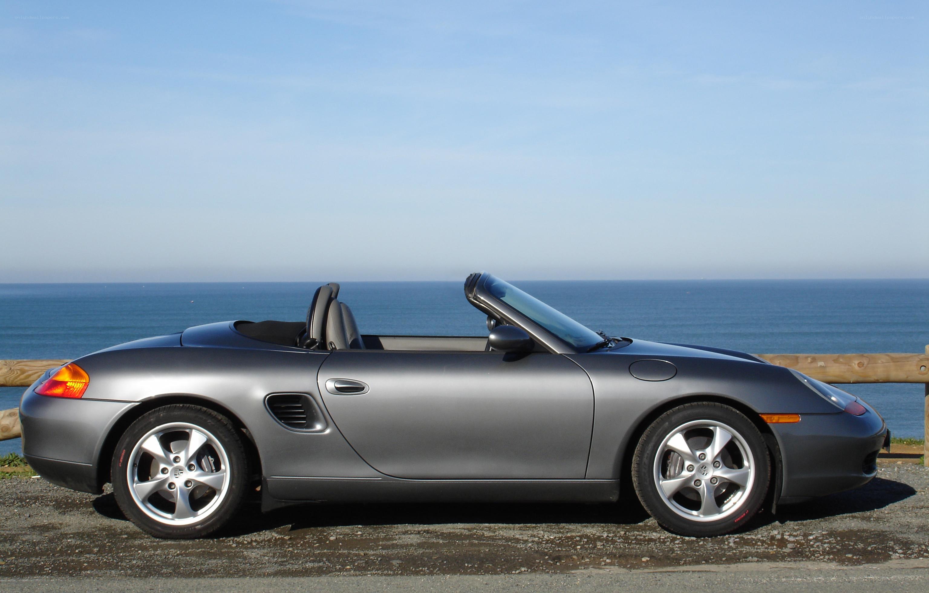 Silver Porsche Boxster by the ocean