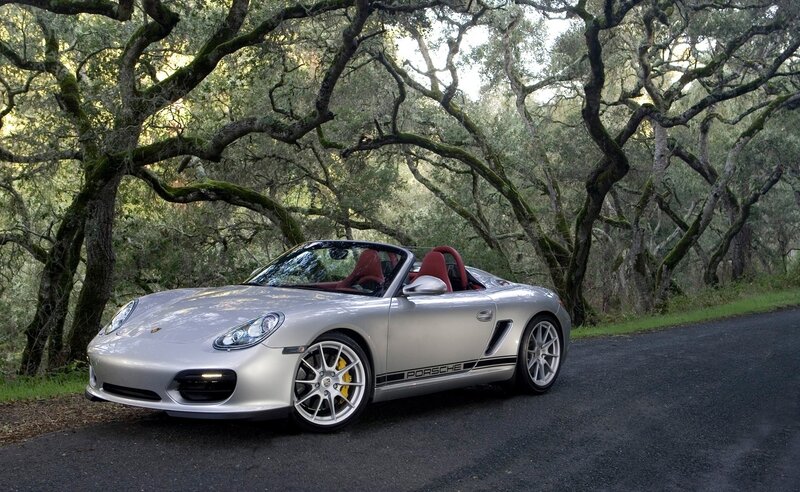 Silver Porsche Boxster on a forest road