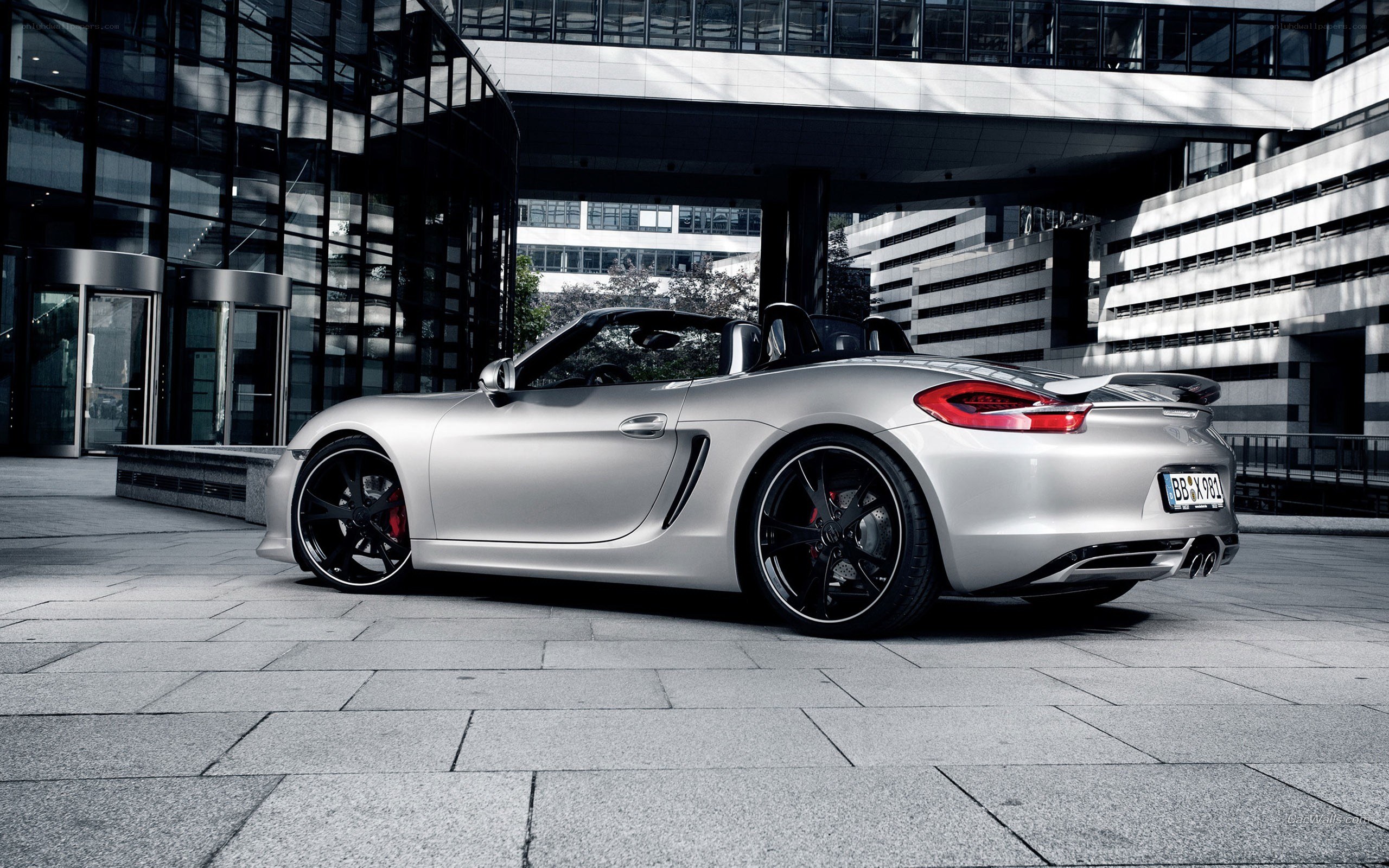 Silver Porsche Boxster parked outside