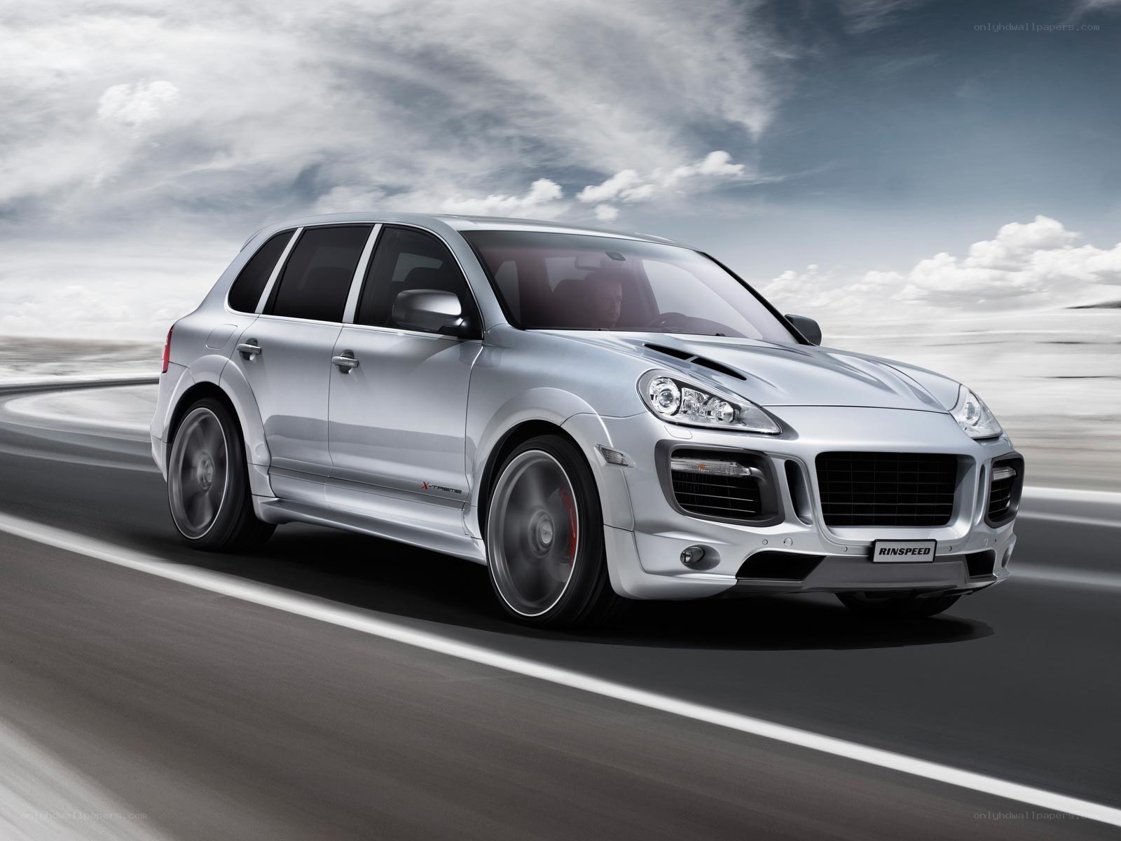 silver porsche cayenne in motion