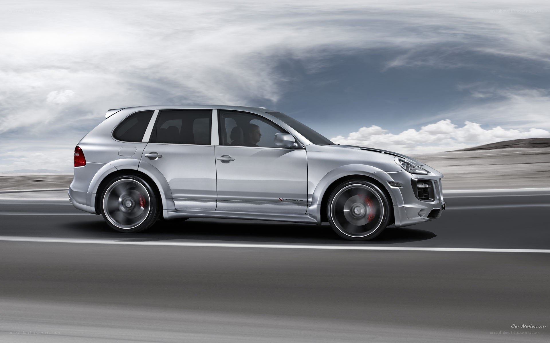 silver porsche cayenne in motion