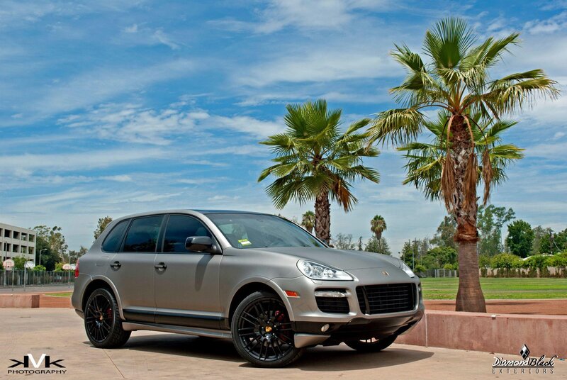 silver porsche cayenne parked by palm trees