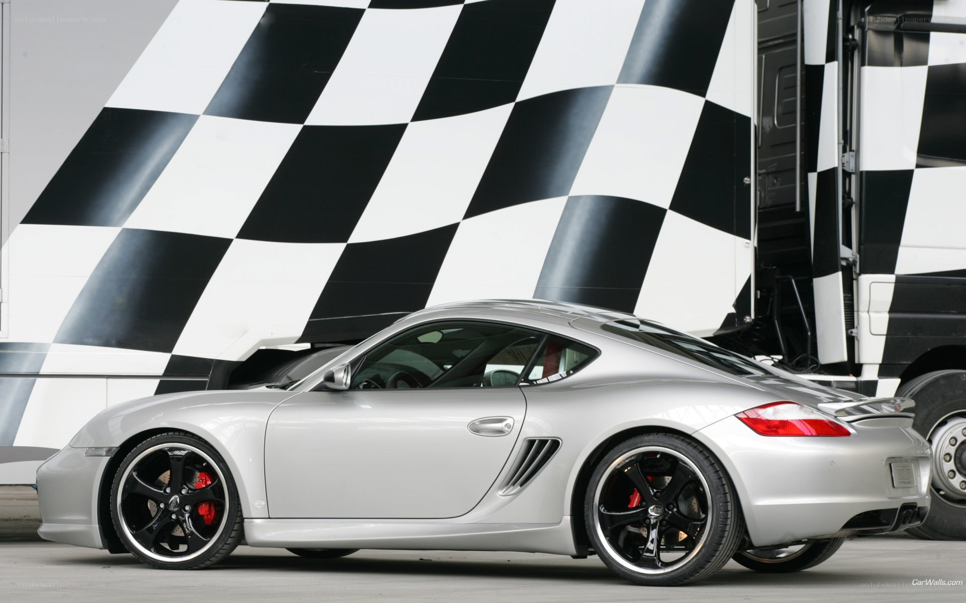 Silver Porsche Cayman with checkered flag