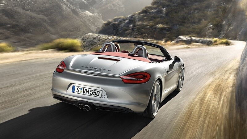 silver porsche convertible driving