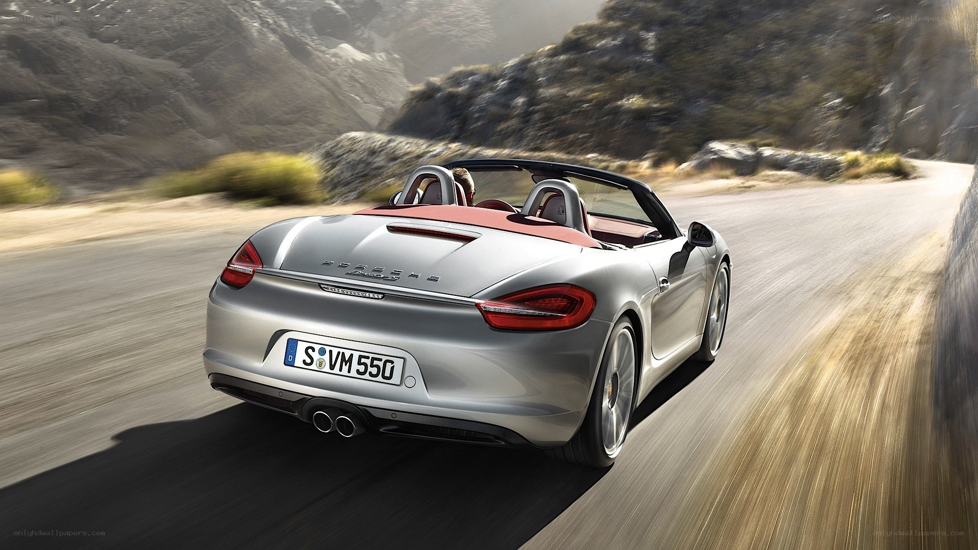 silver porsche convertible driving