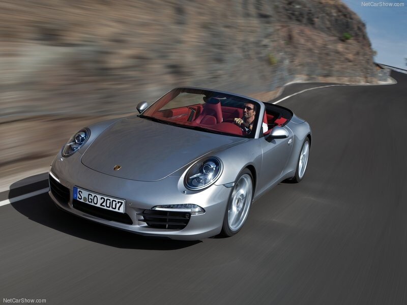silver porsche convertible driving