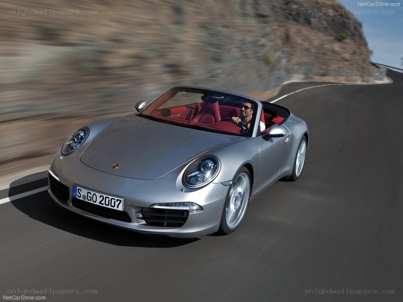 silver porsche convertible driving
