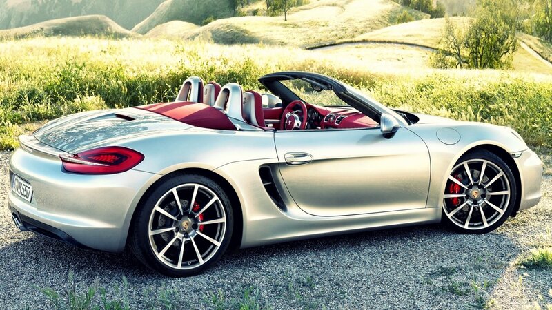 Silver Porsche convertible in field