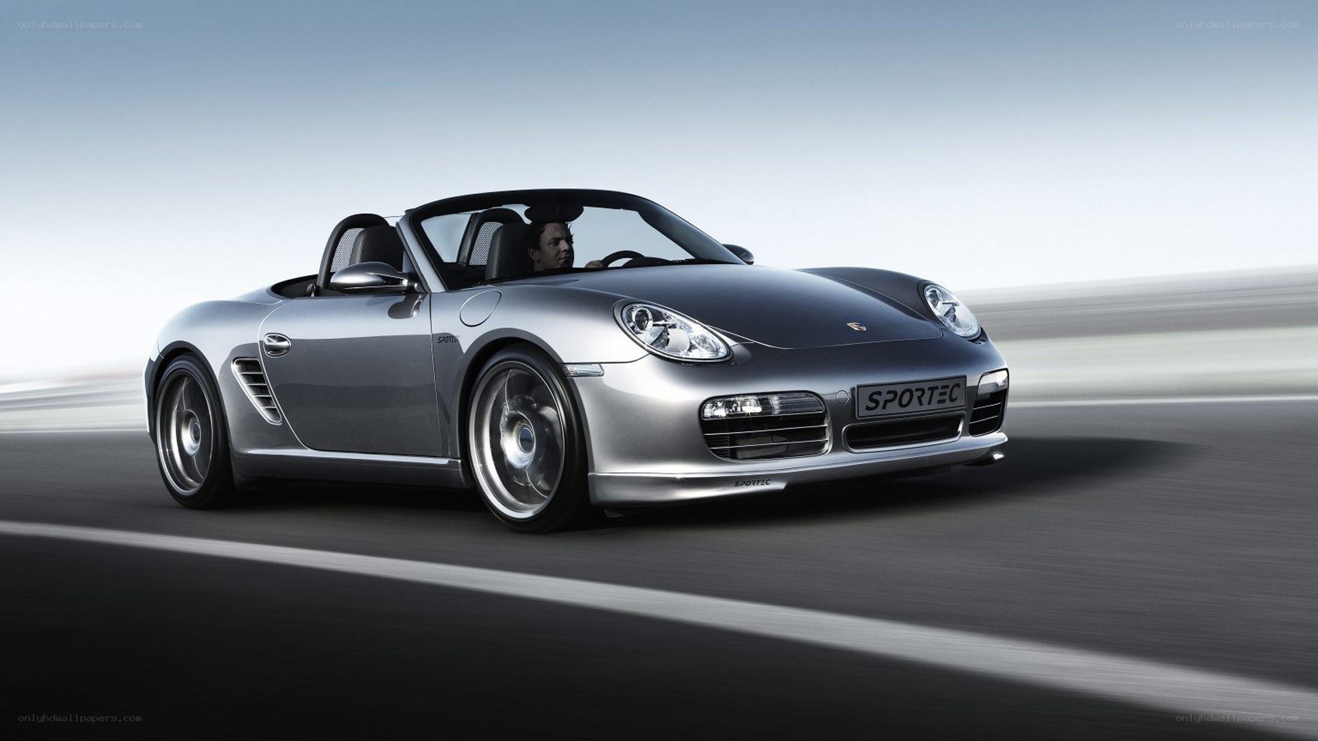Silver Porsche convertible in motion