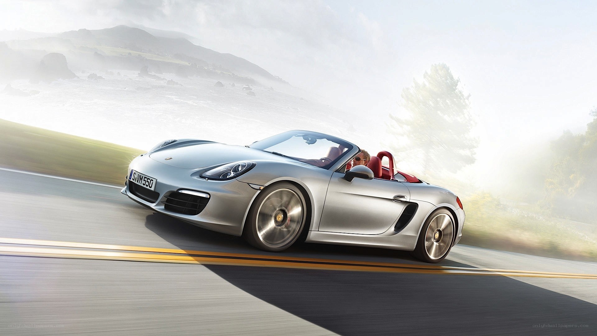 Silver Porsche convertible on road