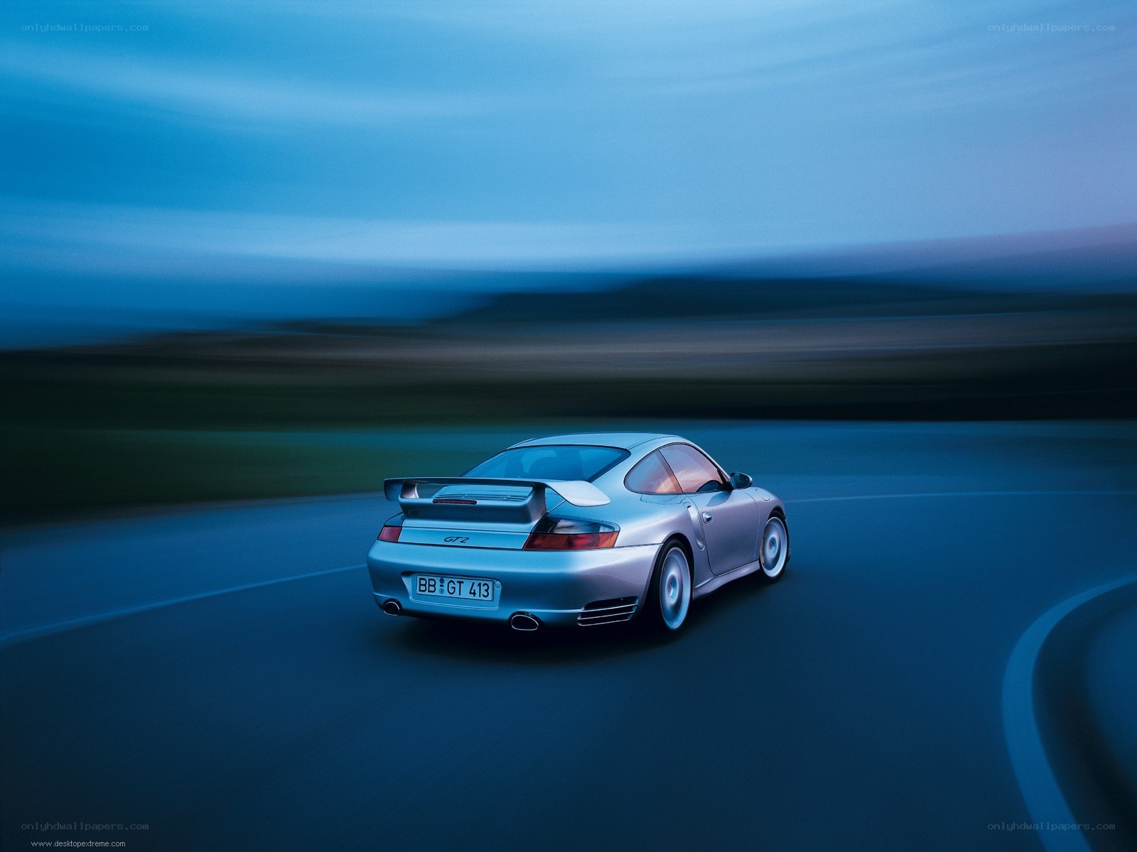 silver porsche driving at night