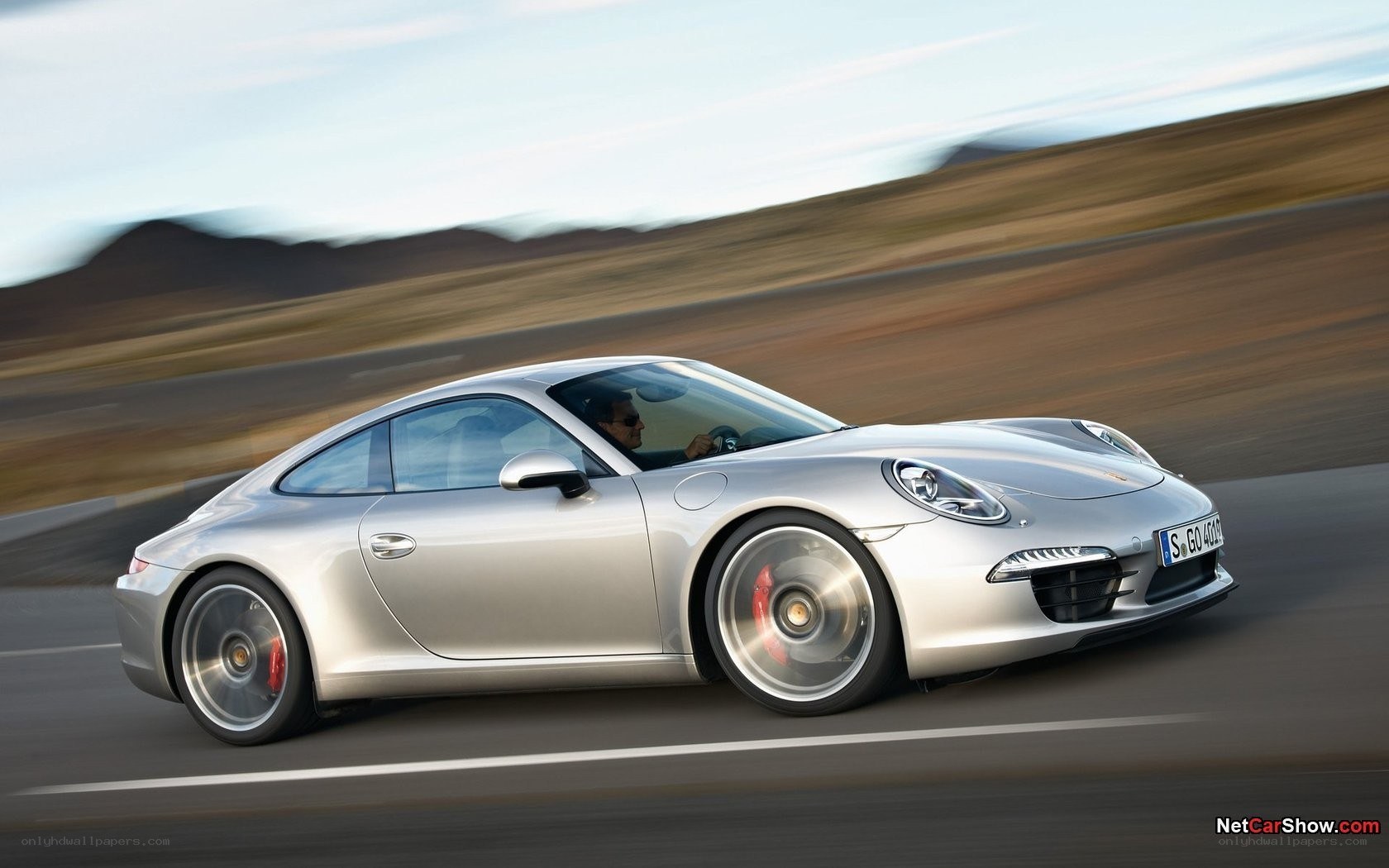 silver porsche driving on road