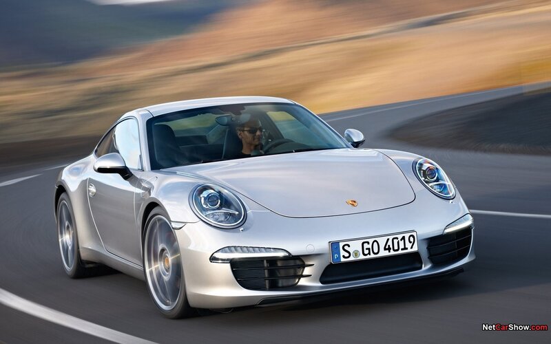 silver porsche driving on road