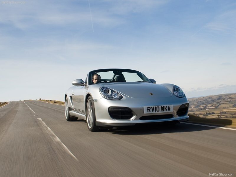 silver porsche driving on road