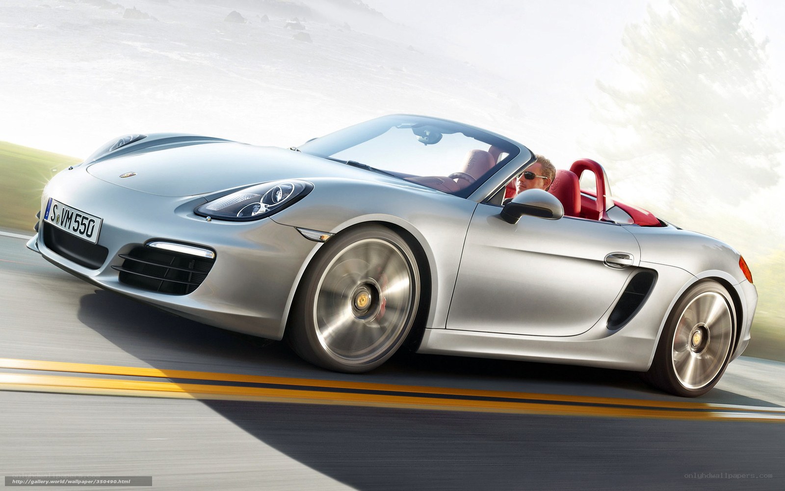 Silver Porsche driving on road