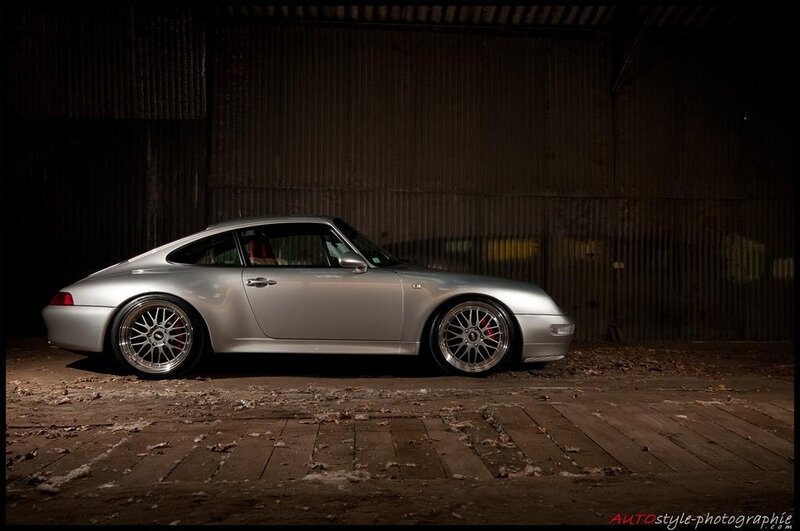 silver porsche in a warehouse