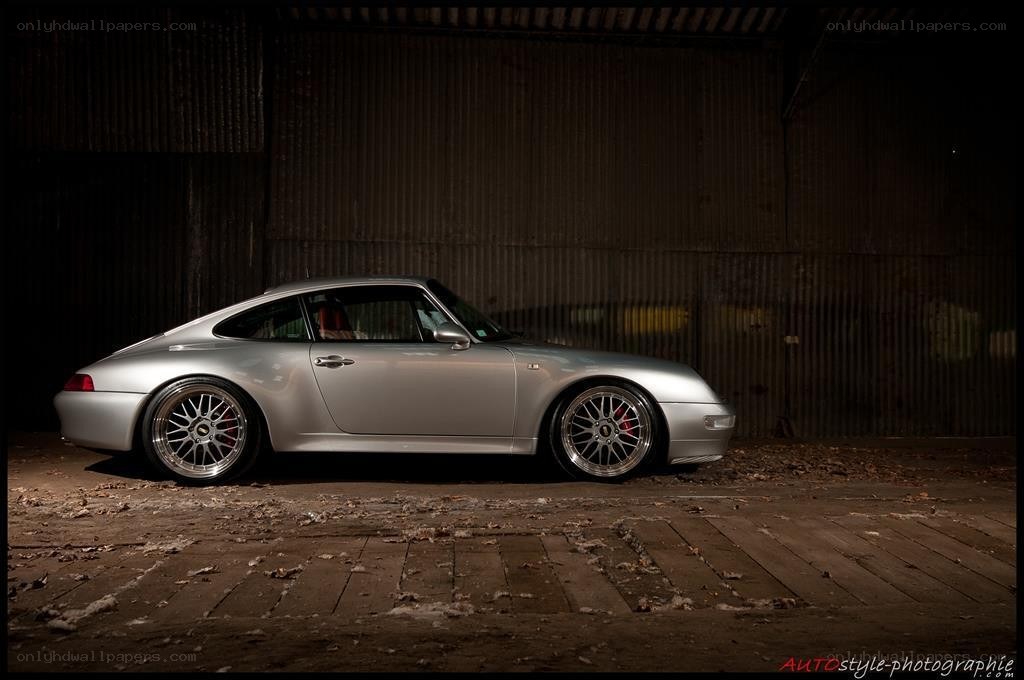 silver porsche in a warehouse