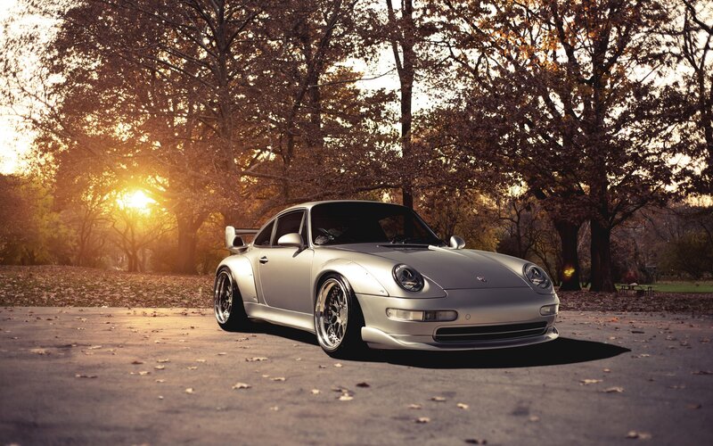 Silver Porsche in autumn park