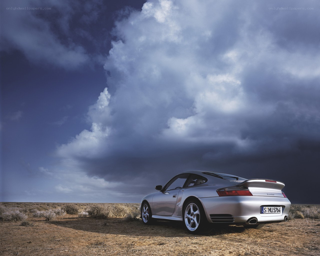 Silver Porsche in desert landscape