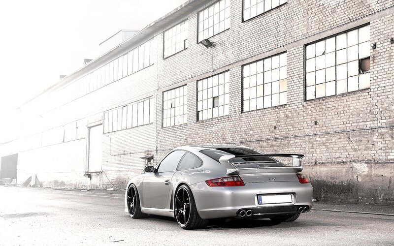 silver porsche in industrial setting