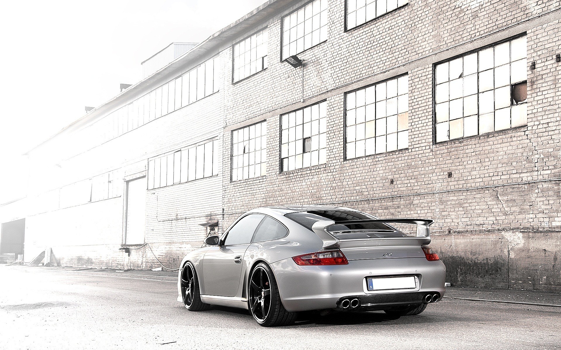 silver porsche in industrial setting