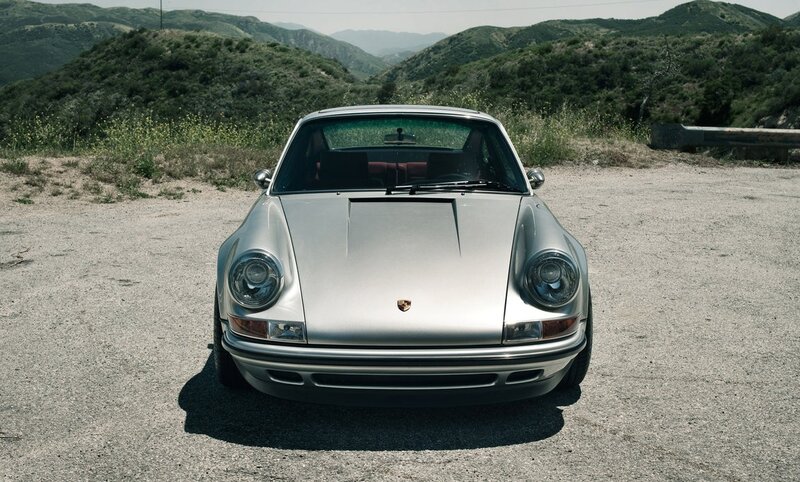 silver porsche in mountain setting