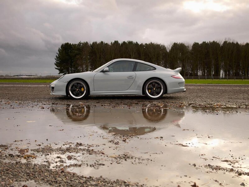 silver porsche in puddle
