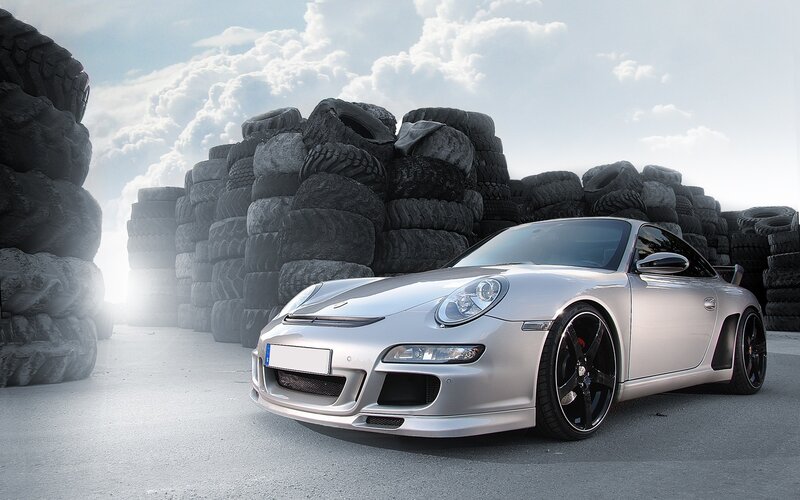 Silver Porsche in tire yard