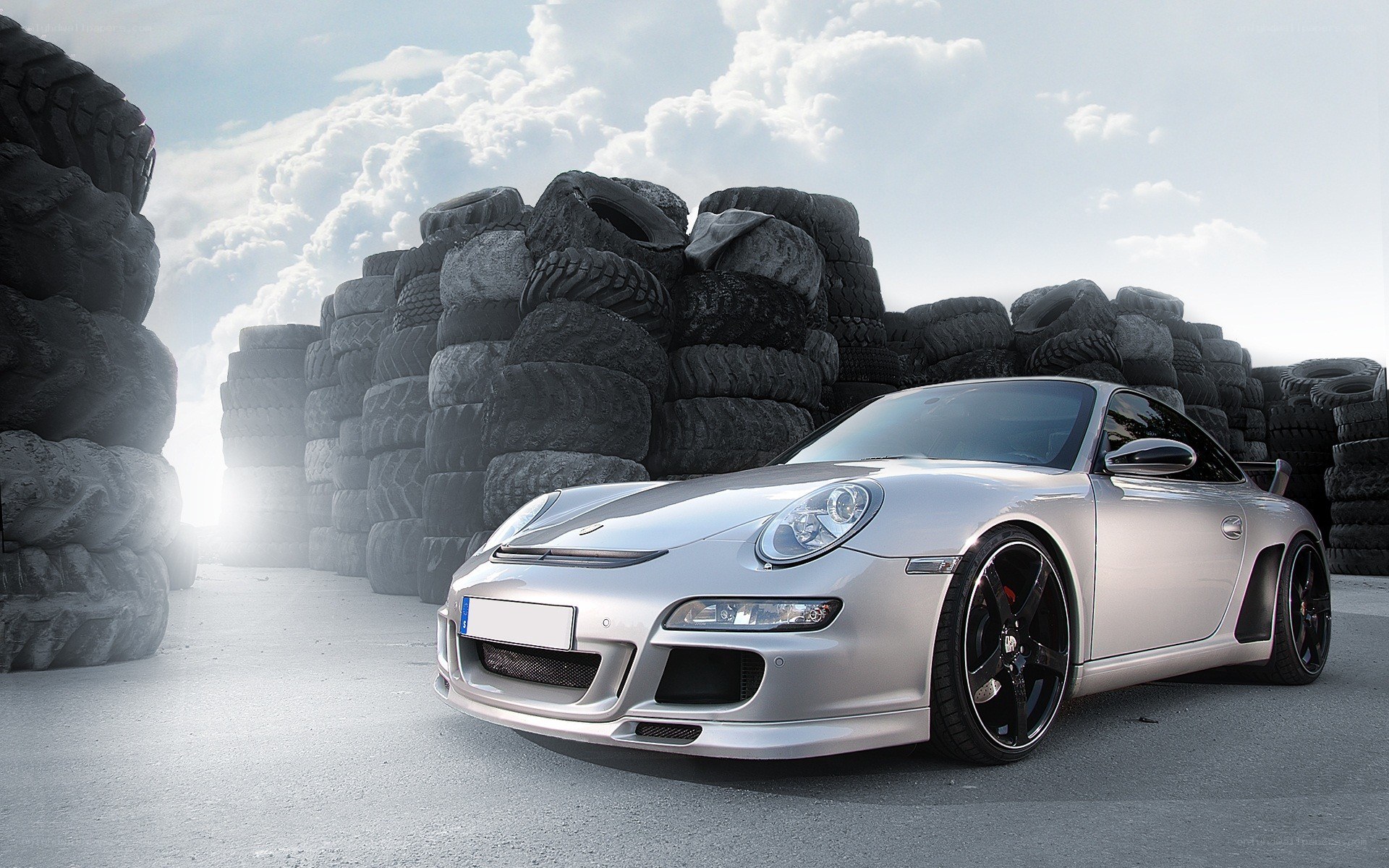 Silver Porsche in tire yard