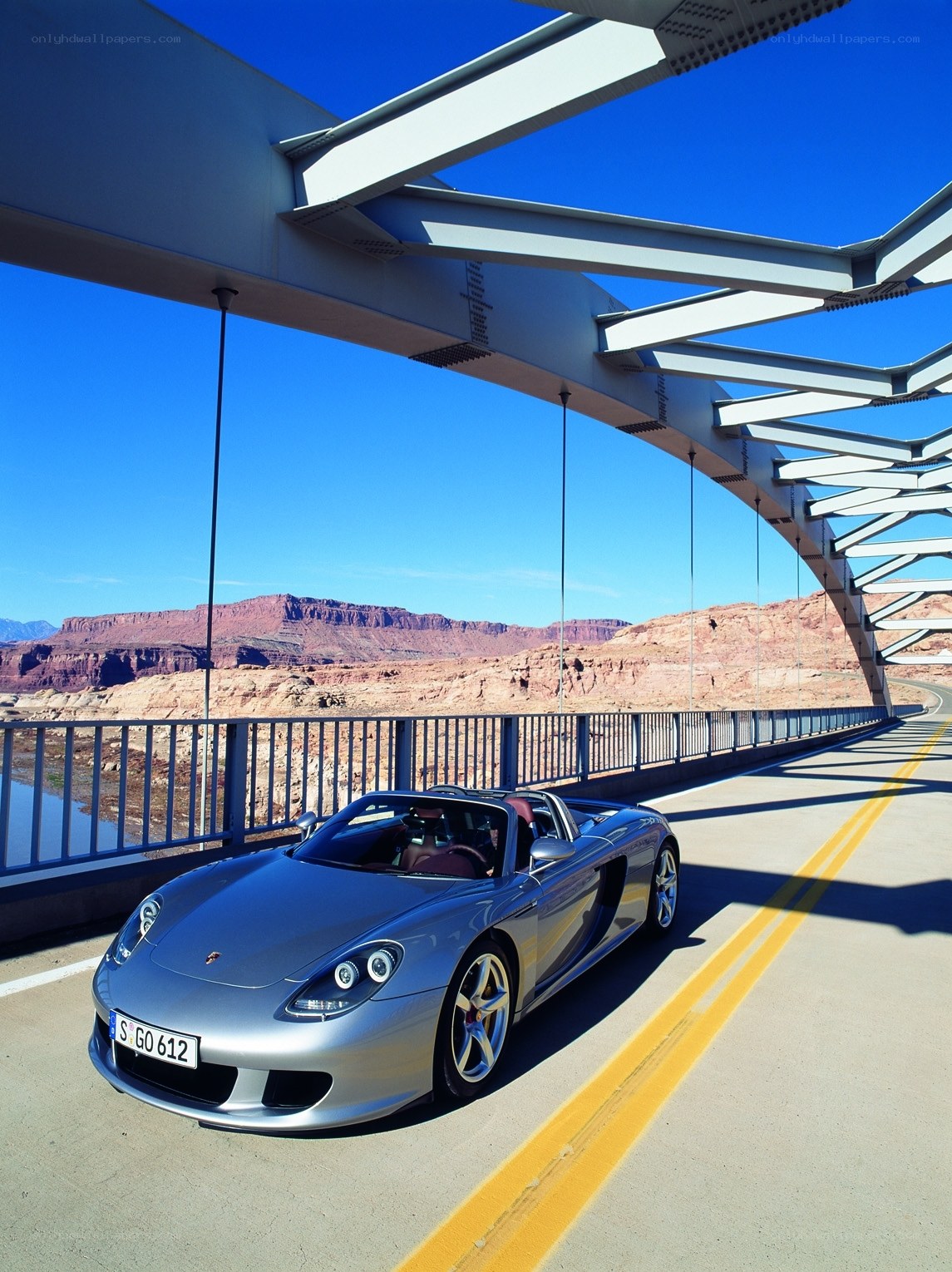 Silver Porsche on a desert bridge