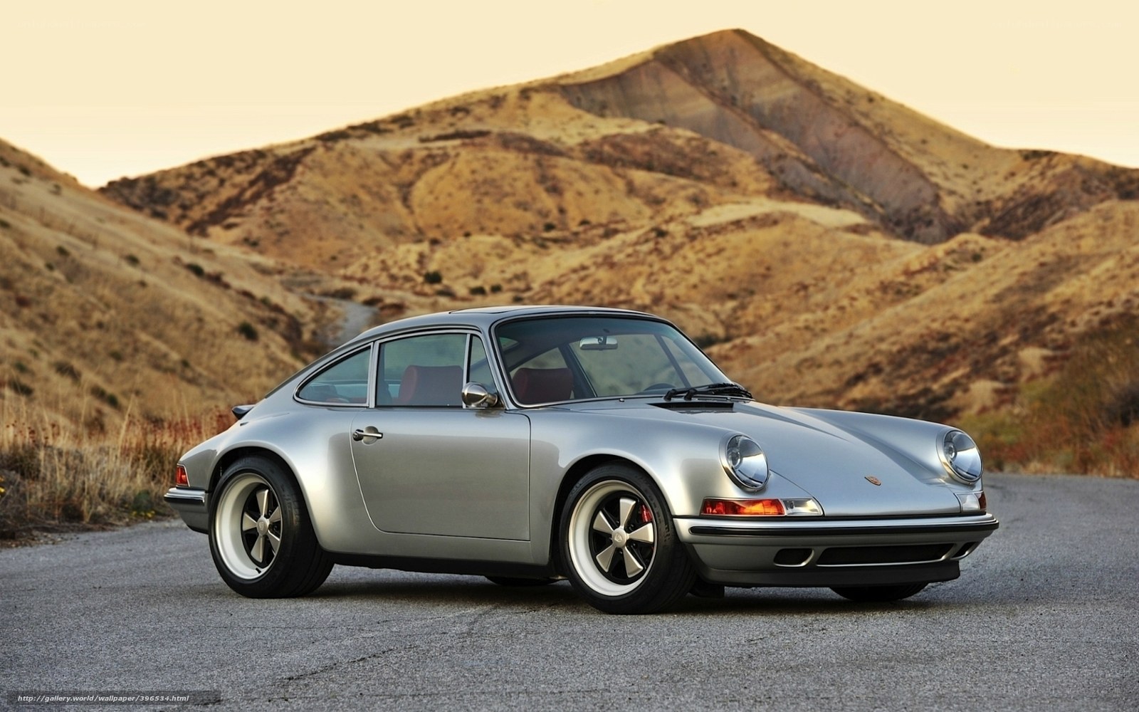 Silver Porsche on a desert road