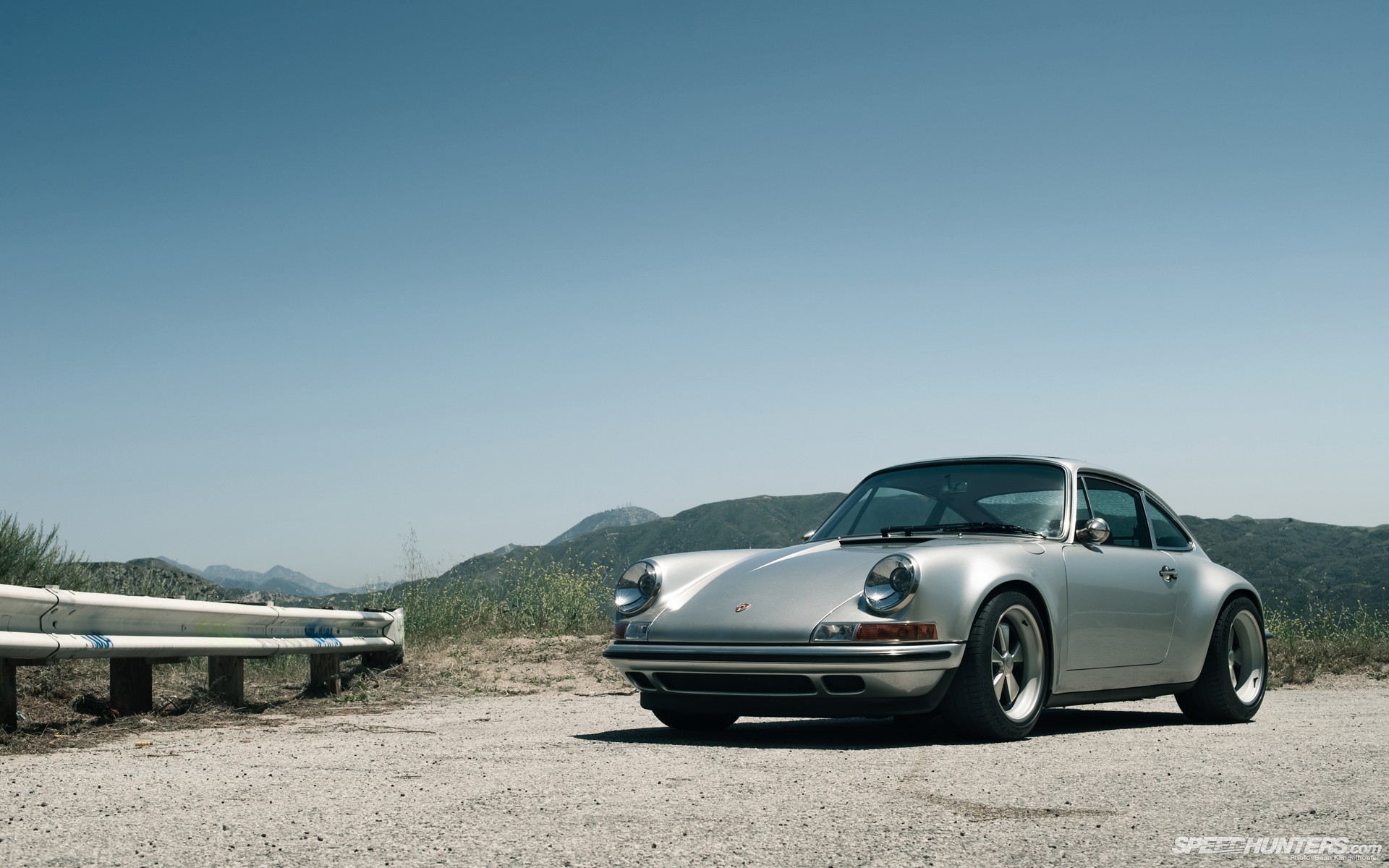 Silver Porsche on a hillside