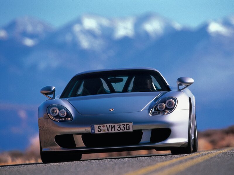 Silver Porsche on a mountain road