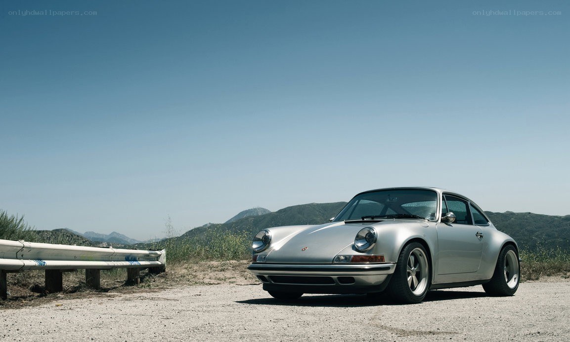 Silver Porsche on a mountain road