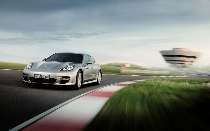 Silver Porsche on a racetrack