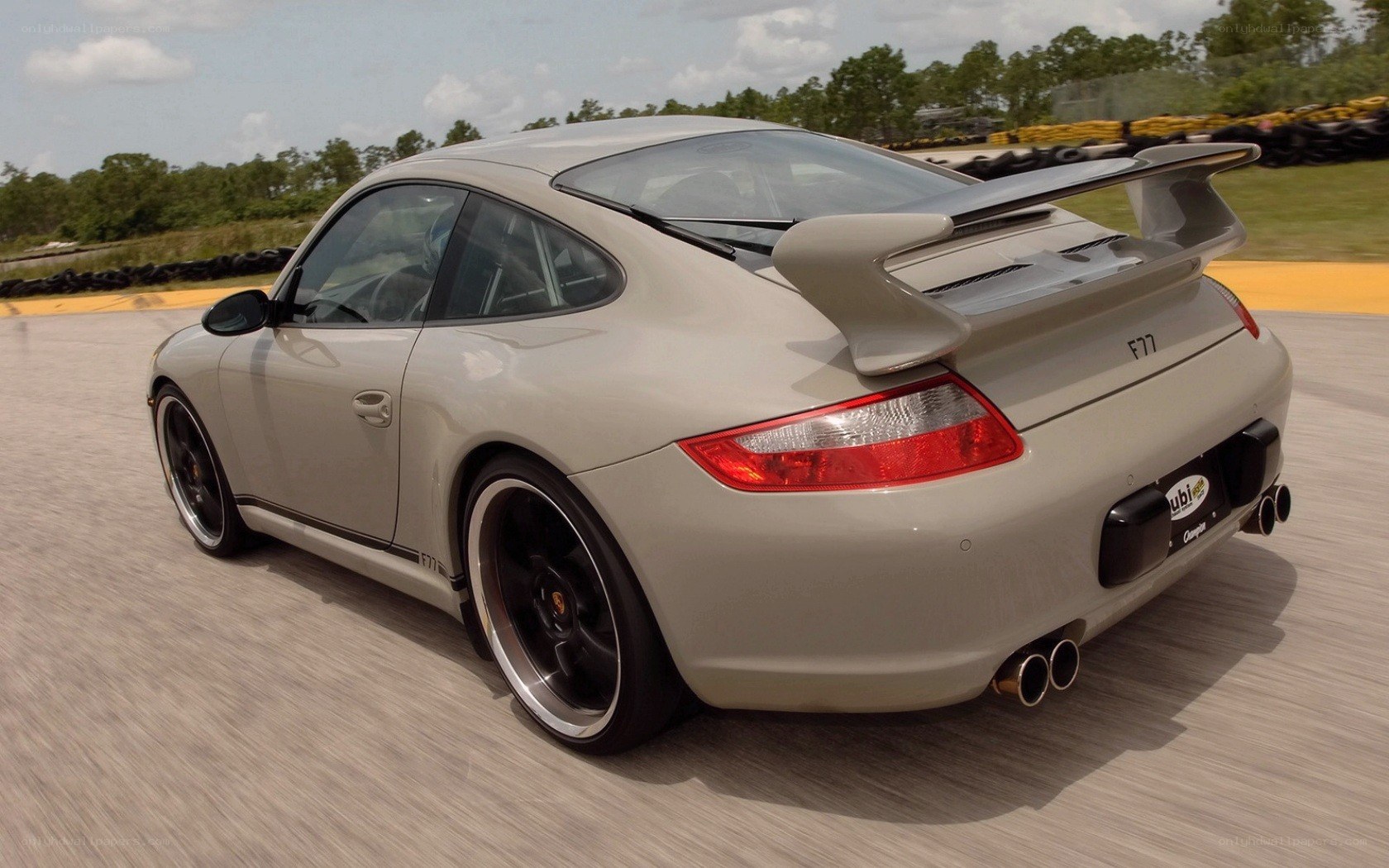 silver porsche on a racetrack