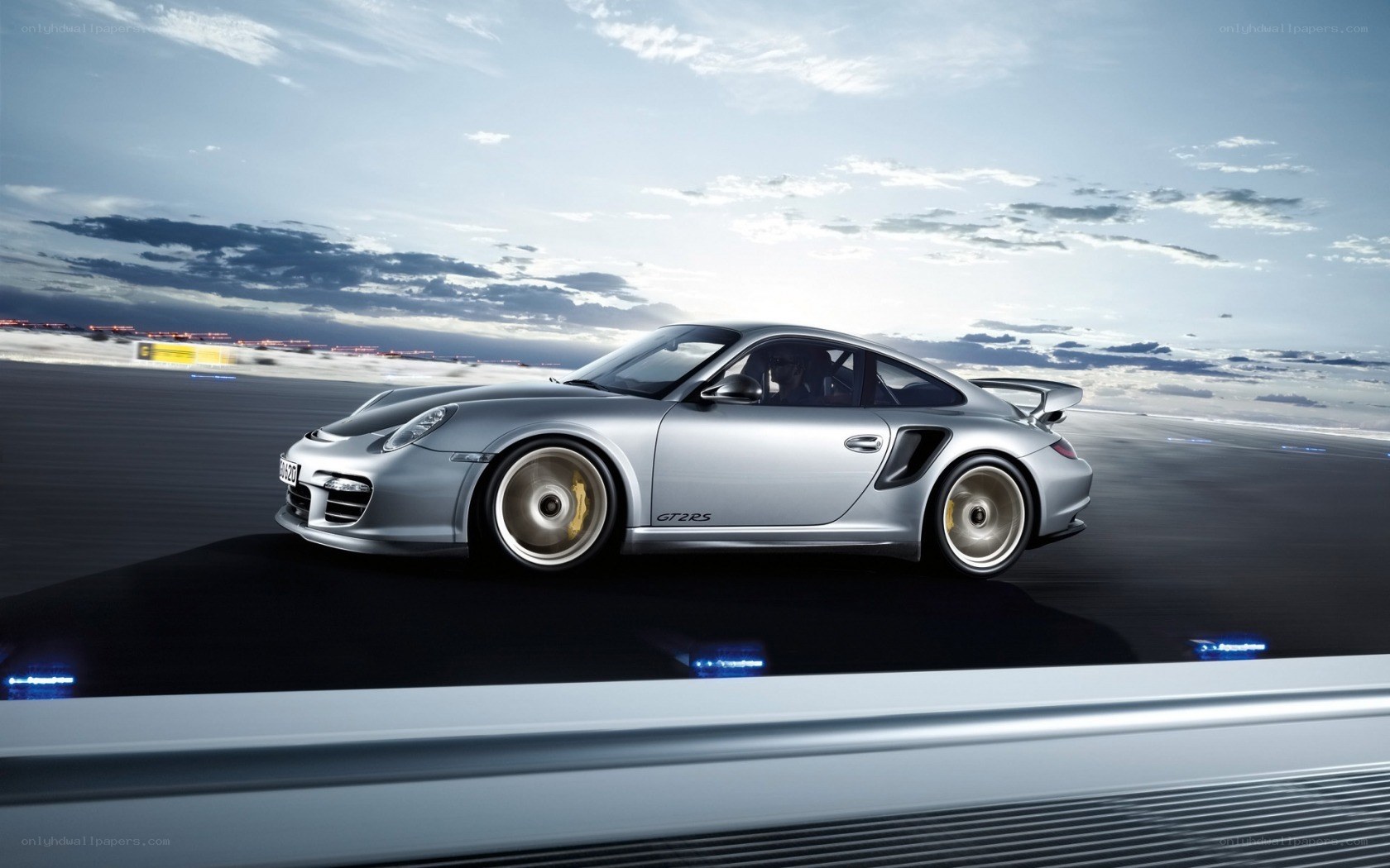 Silver Porsche on a racetrack