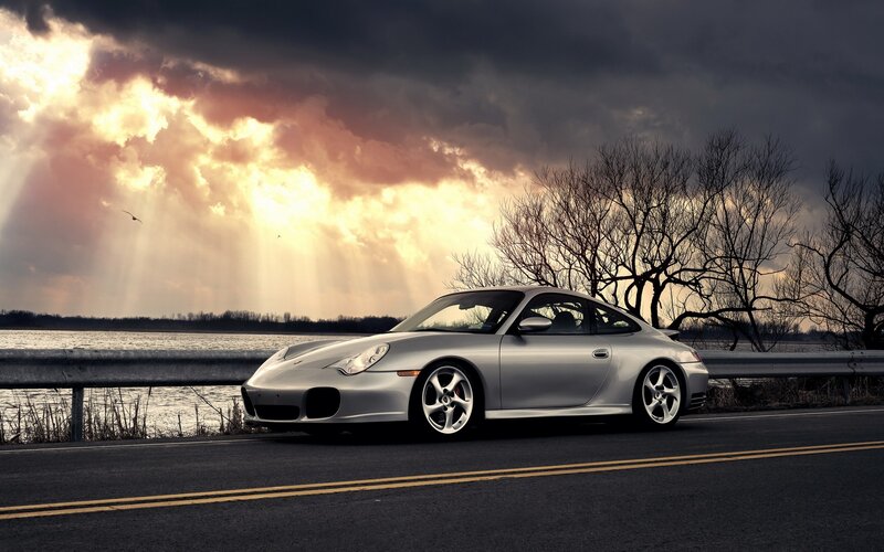 Silver Porsche on a scenic road