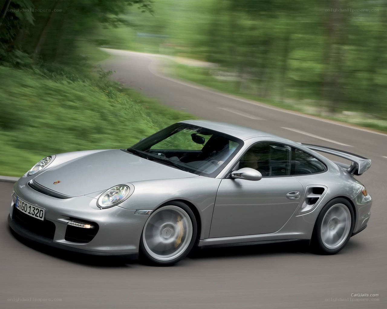 Silver Porsche on a winding road