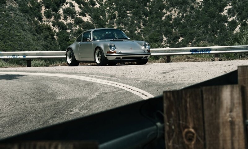 Silver Porsche on a winding road