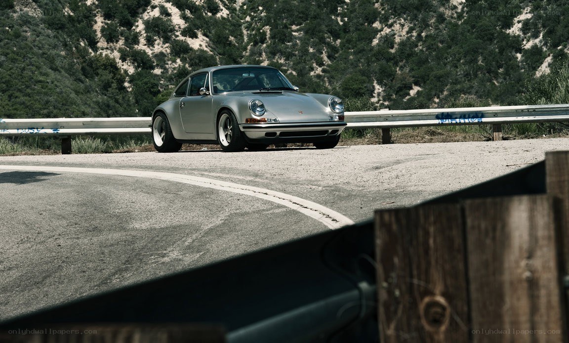 Silver Porsche on a winding road