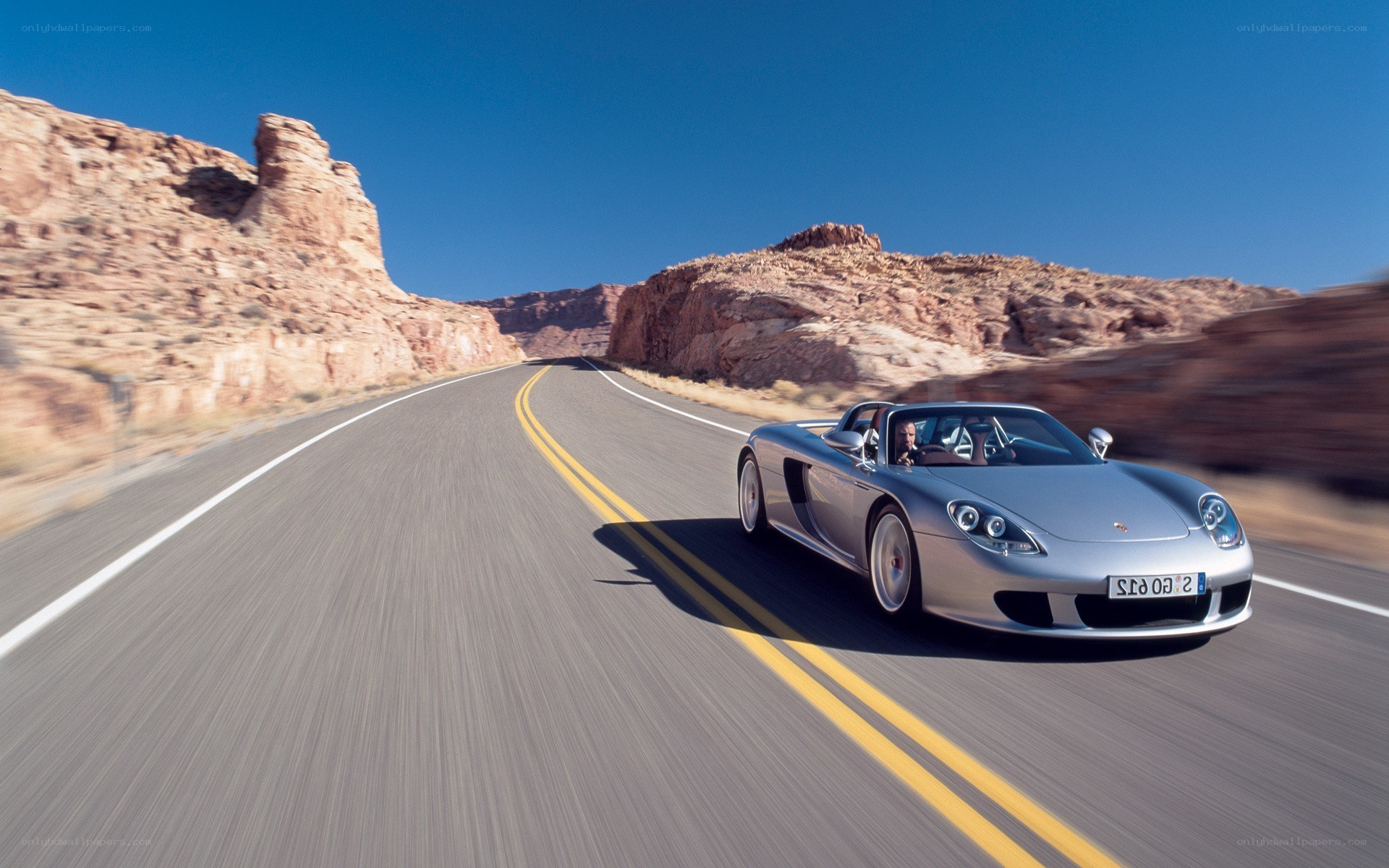 Silver Porsche on desert road
