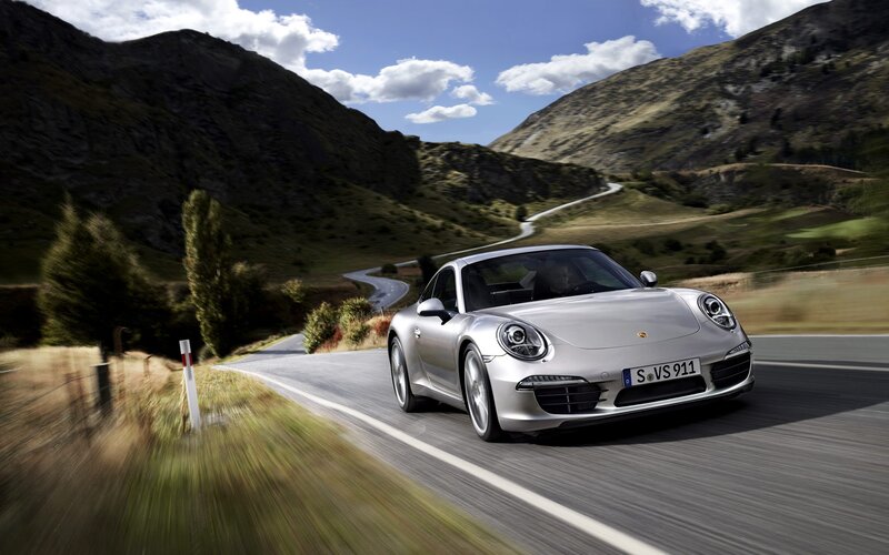 Silver Porsche on mountain road